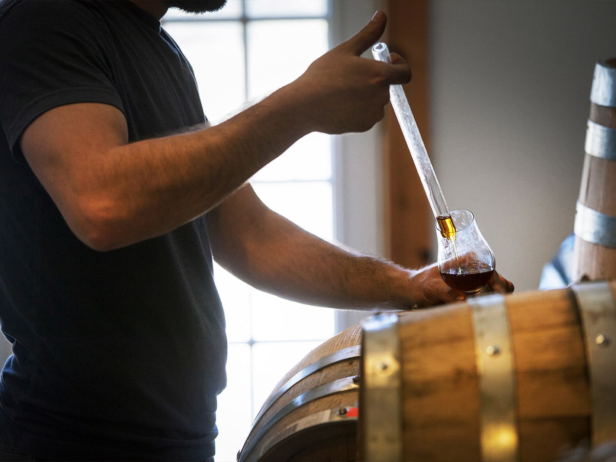 Collecting whiskey from a barrel